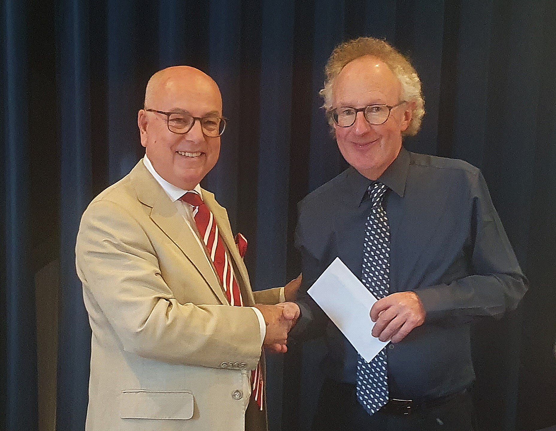 The Provincial Prior presents the Choir Master with a donation